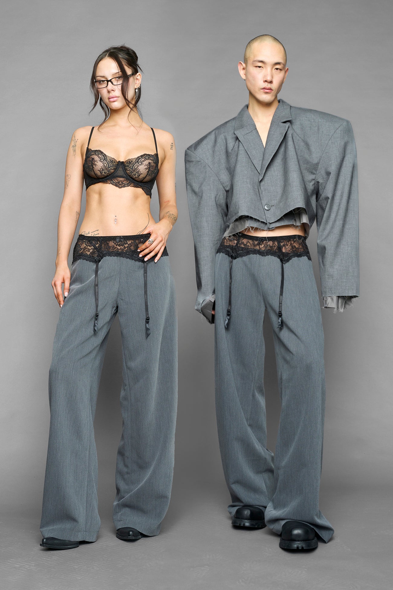 model wearing grey baggy suiting pants with garter lace waist detail