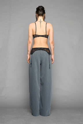 model wearing grey baggy suiting pants with garter lace waist detail