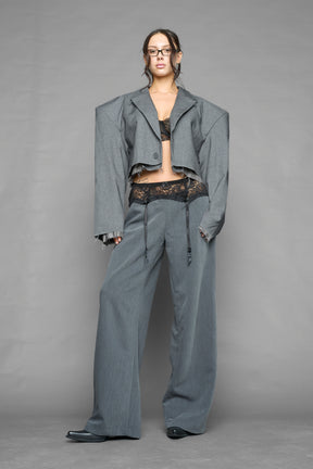 model wearing grey baggy suiting pants with garter lace waist detail