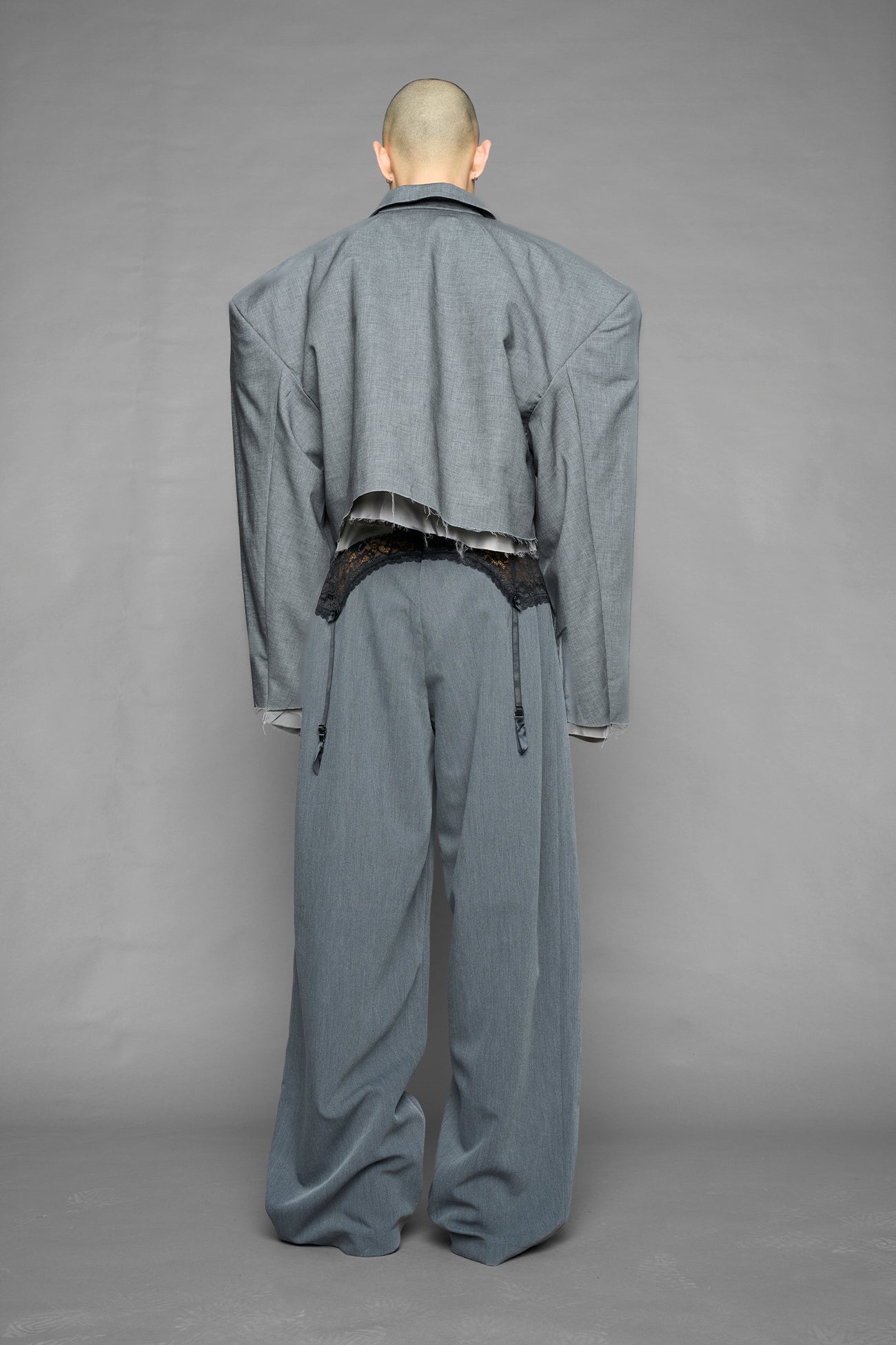 model wearing grey print baggy suiting pants with garter lace waist detail