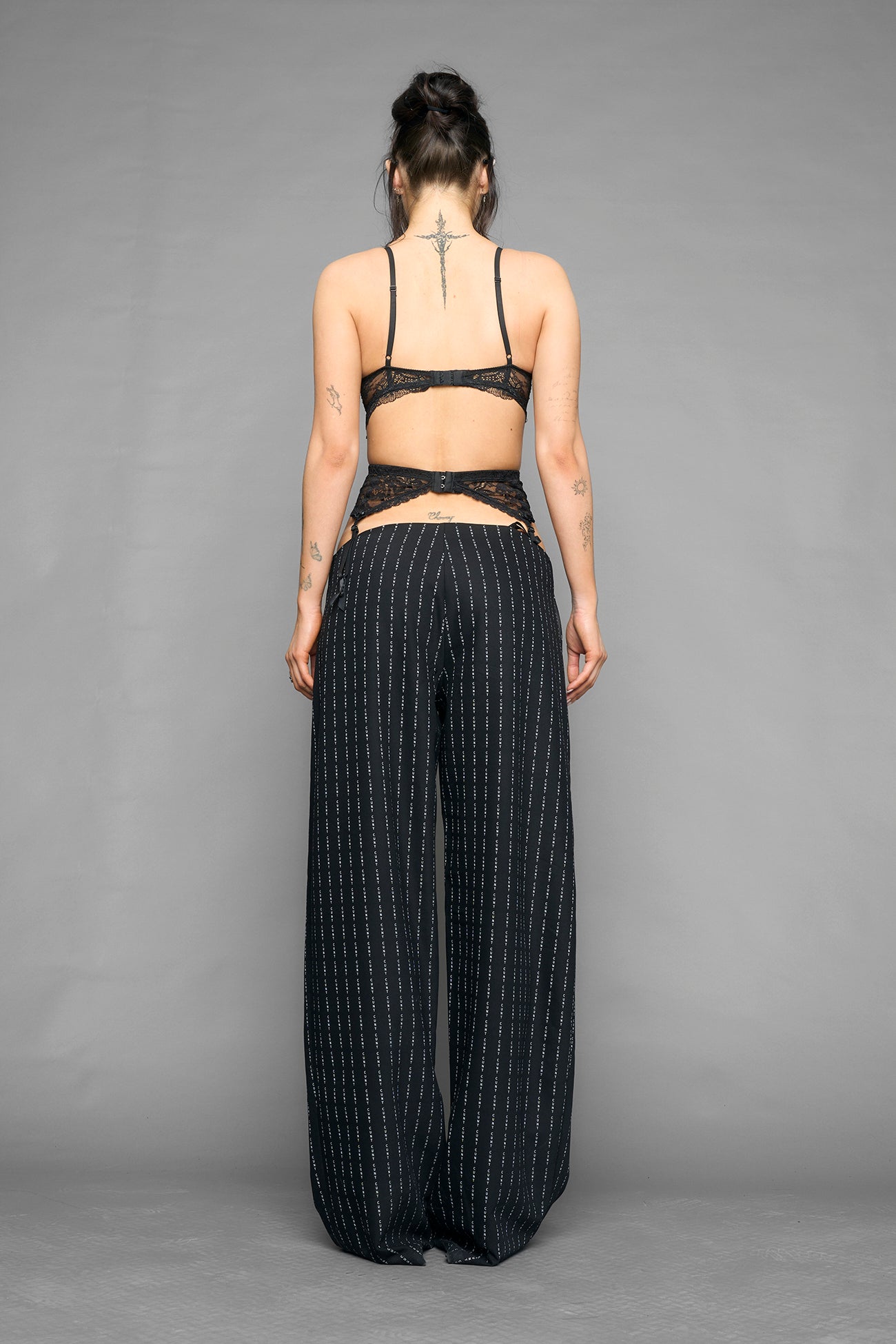 model wearing suspender lace office baggy pants in wool blend