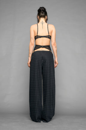 model wearing suspender lace office baggy pants in wool blend