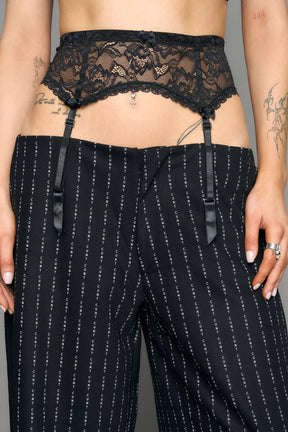 model wearing suspender lace office baggy pants in wool blend