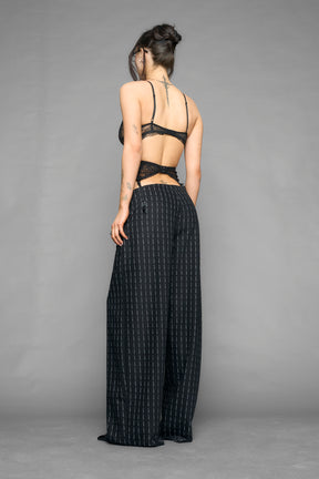 model wearing suspender lace office baggy pants in wool blend