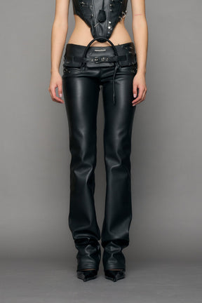 model wearing black pu leather studded handbag pants