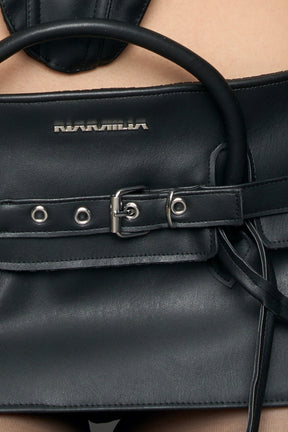 model wearing black pu leather handbag skirt