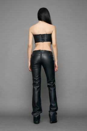 model wearing black pu leather studded handbag pants