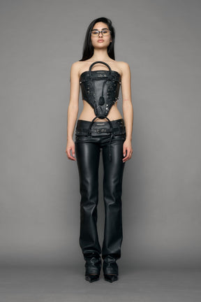 model wearing black pu leather studded handbag pants