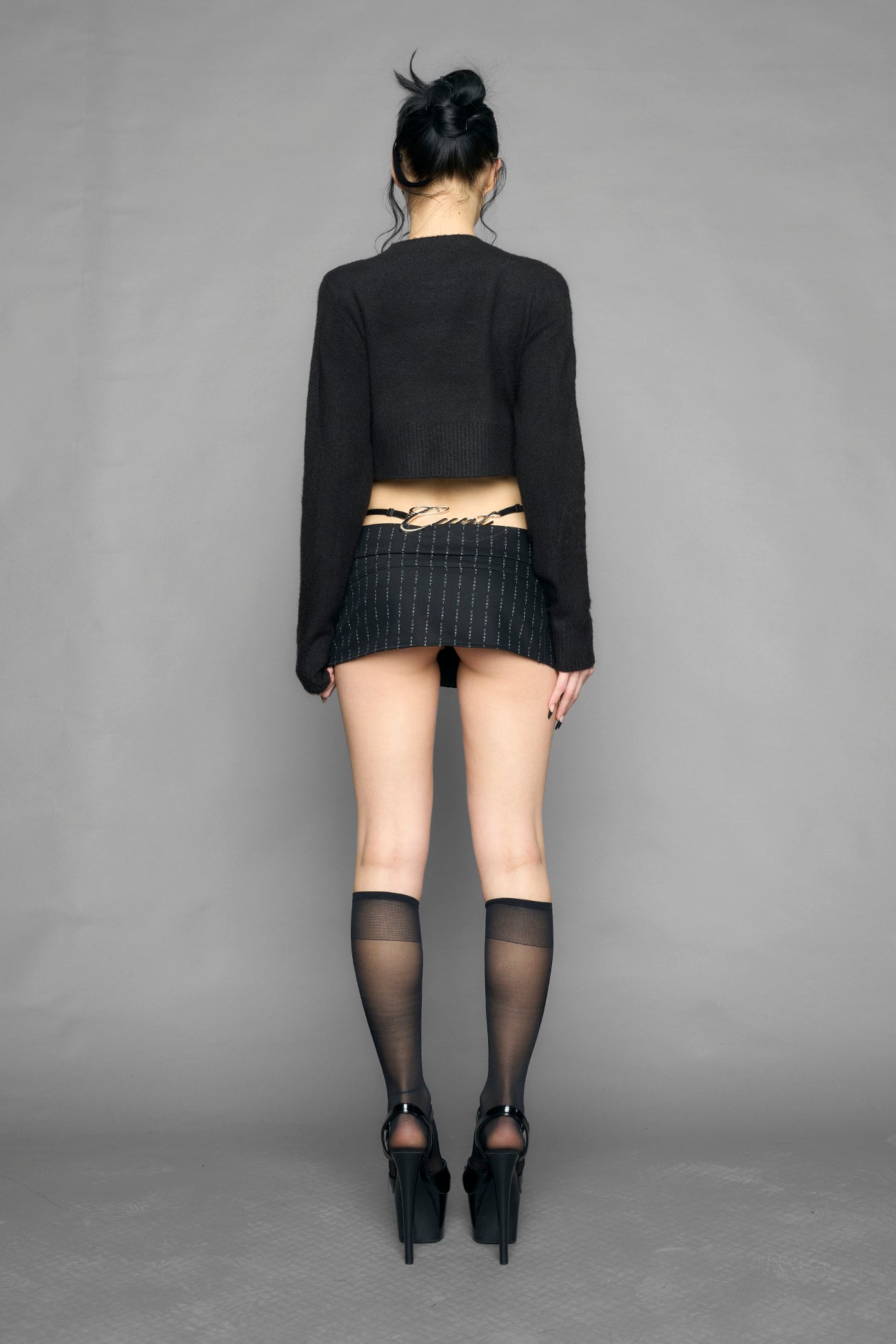 model wearing intarsia knit wool sweater cropped length black