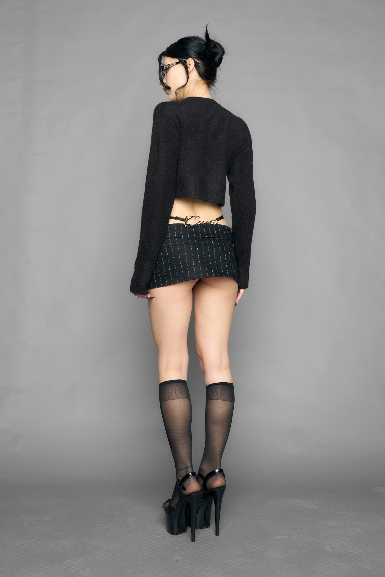 model wearing intarsia knit wool sweater cropped length black