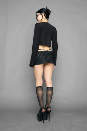 model wearing intarsia knit wool sweater cropped length black