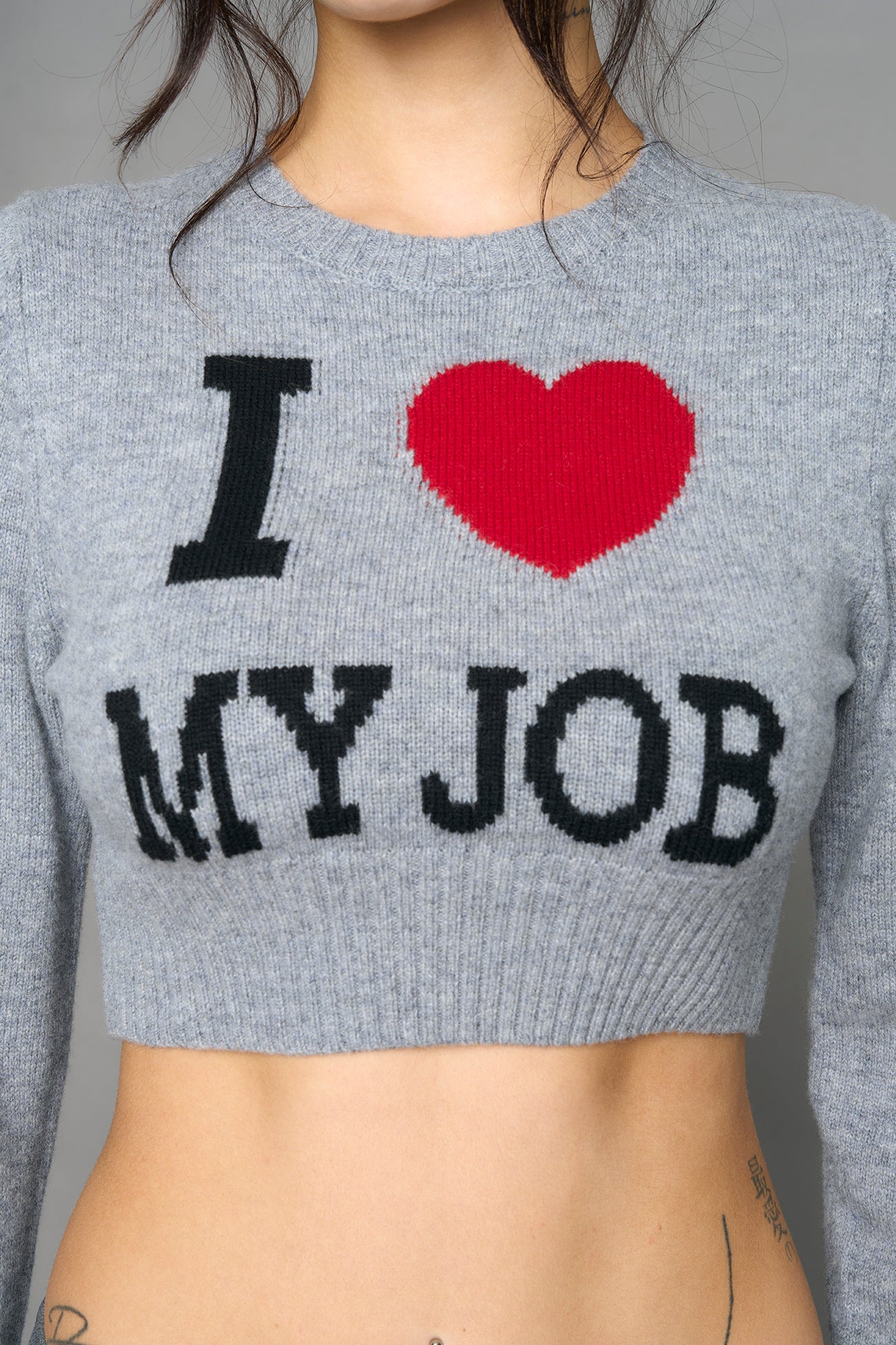 model wearing intarsia knit wool sweater cropped length grey