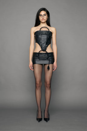 model wearing black pu leather handbag skirt