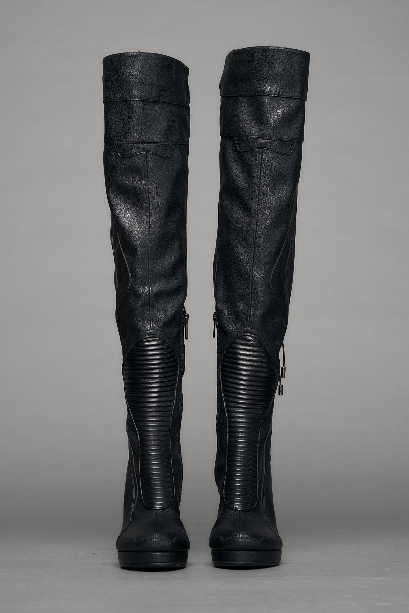Black leather wedge boot on a gray background