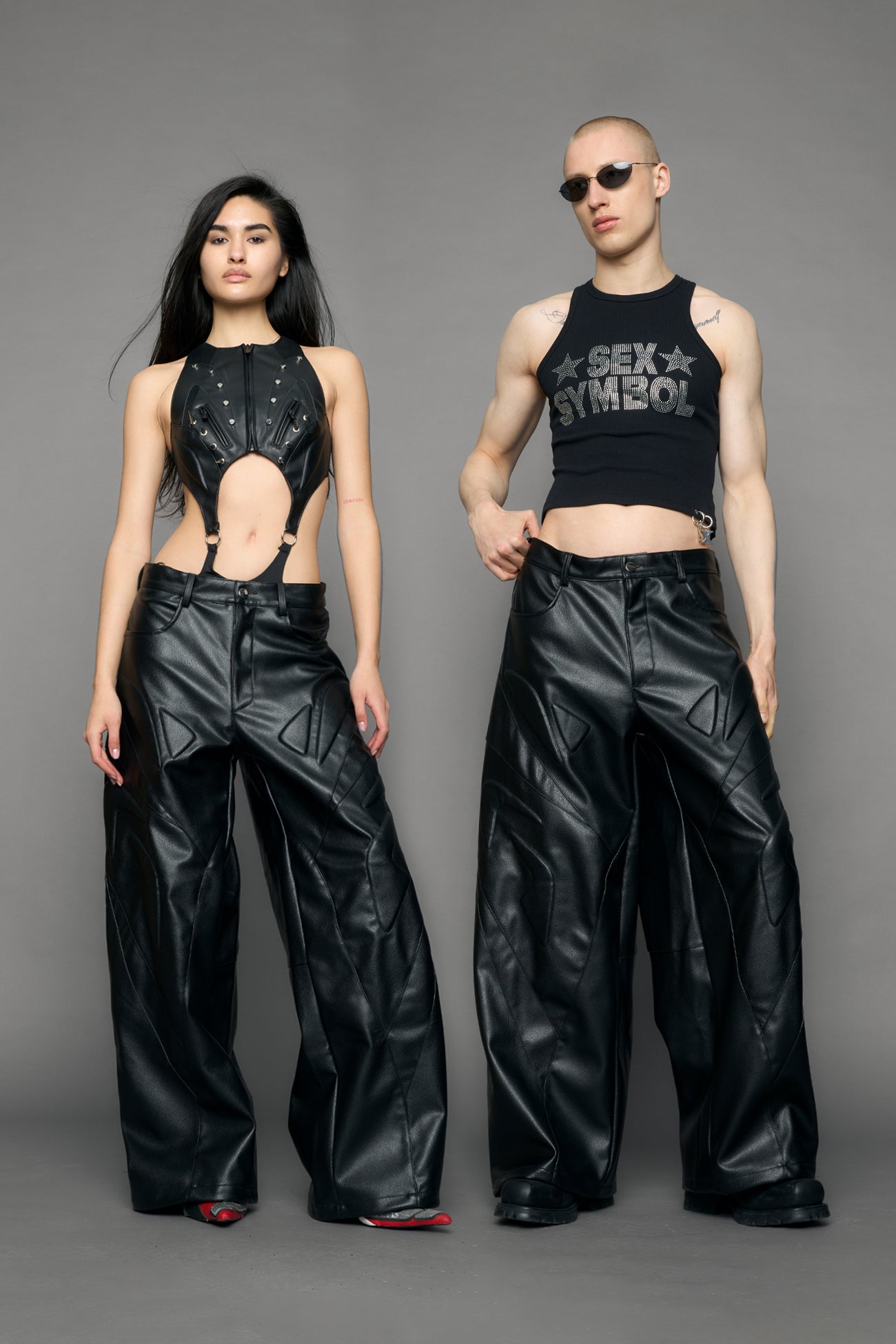 model wearing black oversize pu leather pants with moto style highlights