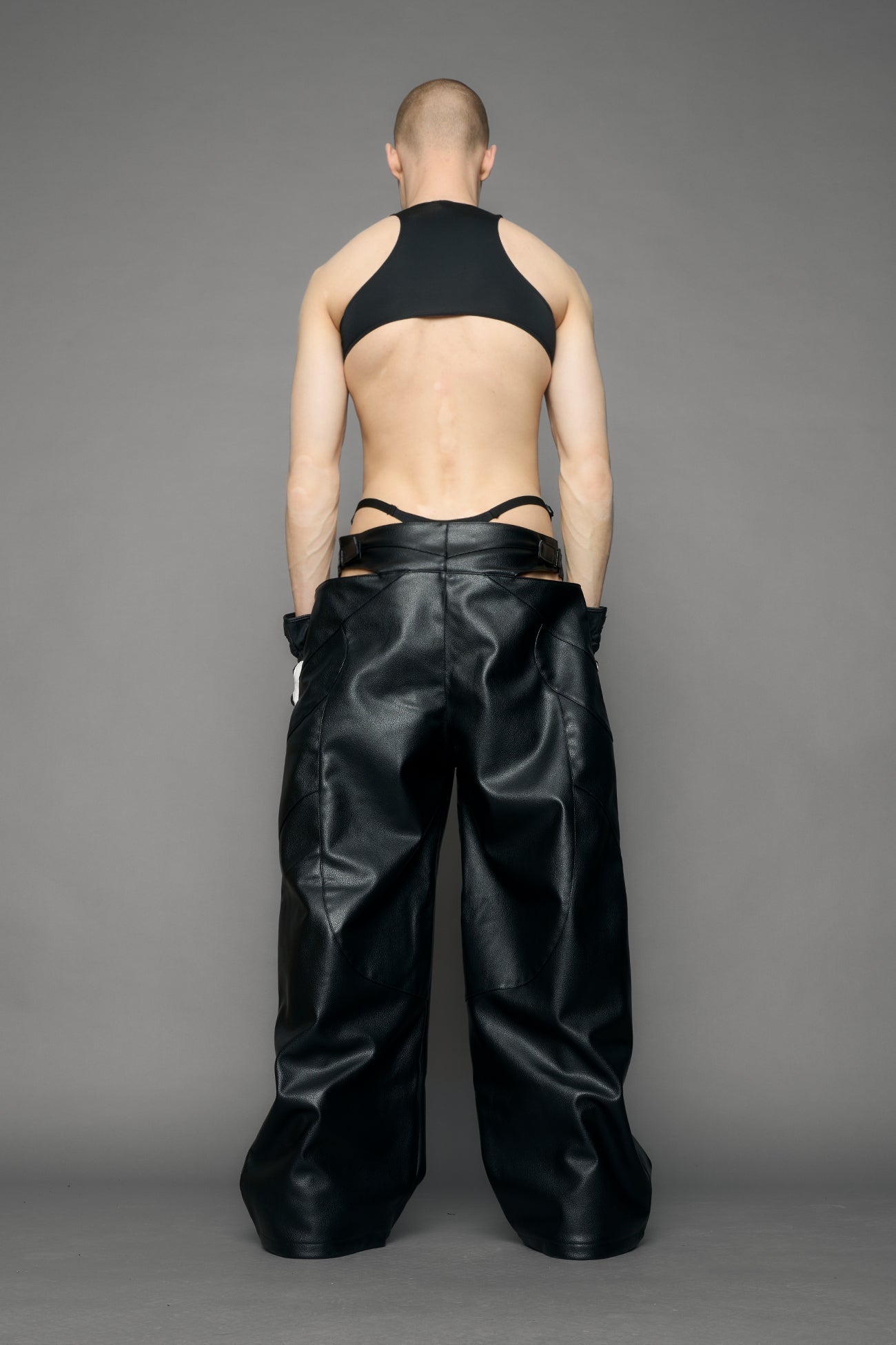 model wearing black pu leather body with loose panty and moto style lines