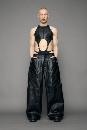 model wearing black pu leather trousers with thong design and moto style highlights