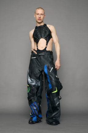 Person wearing a black bodysuit with cut-out design on a gray background