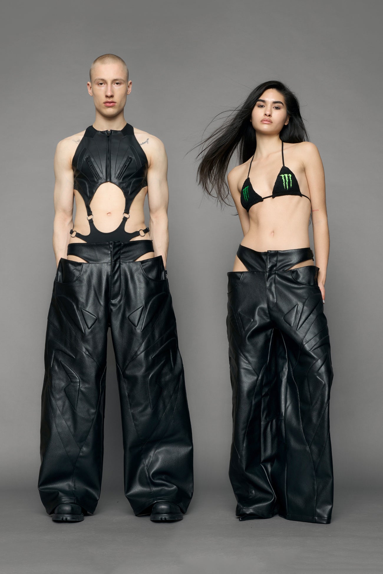 models wearing black pu leather trousers with thong design and moto style highlights