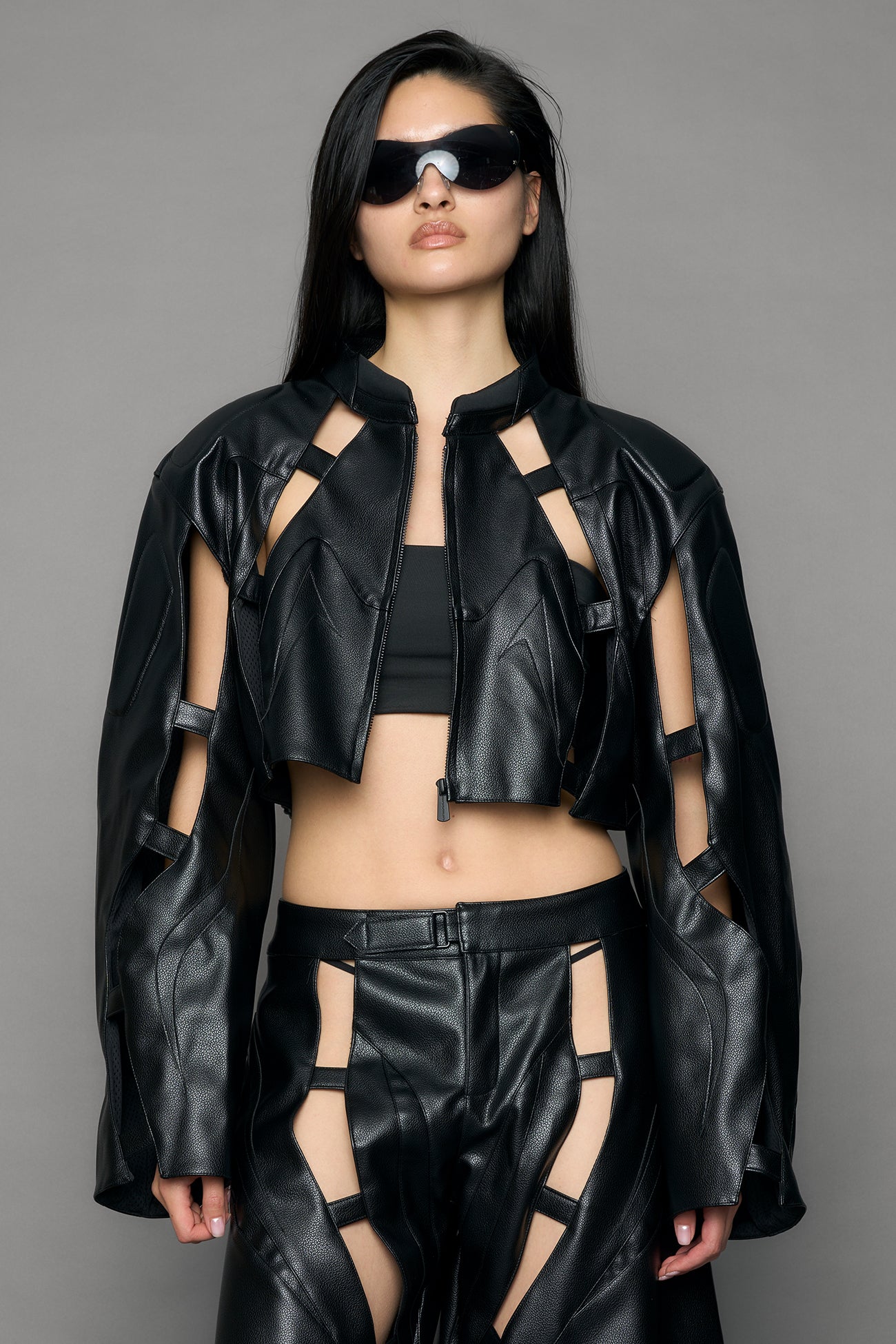model wearing black moto pu leather jacket with cut out design