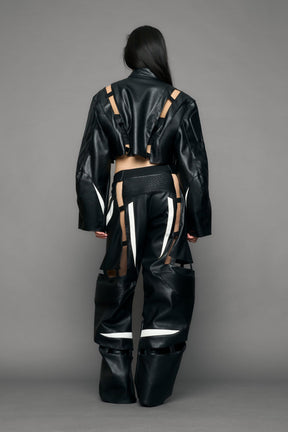 model wearing black and white pu leather pants with cut out details