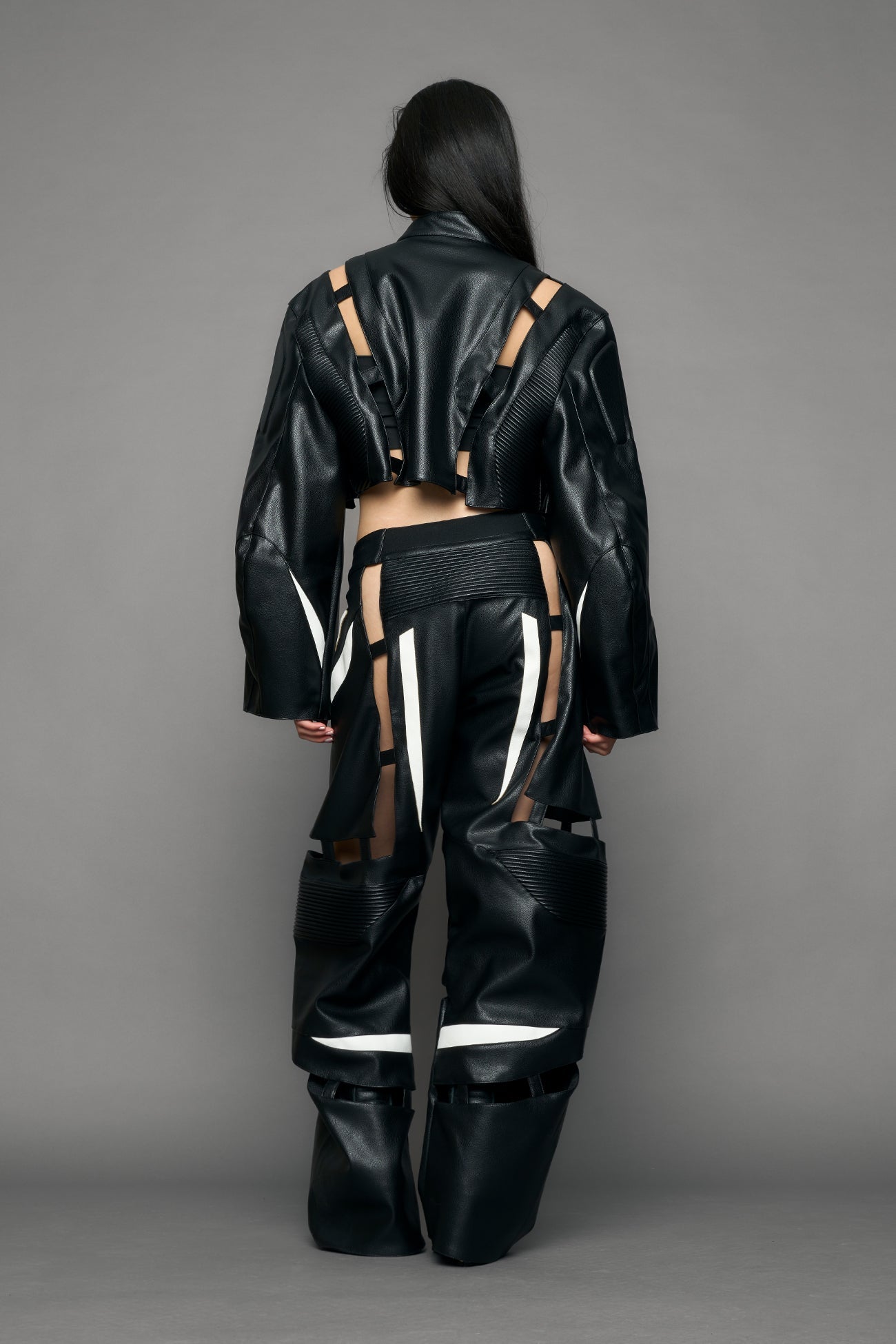 model wearing black and white moto pu leather jacket with cut out design