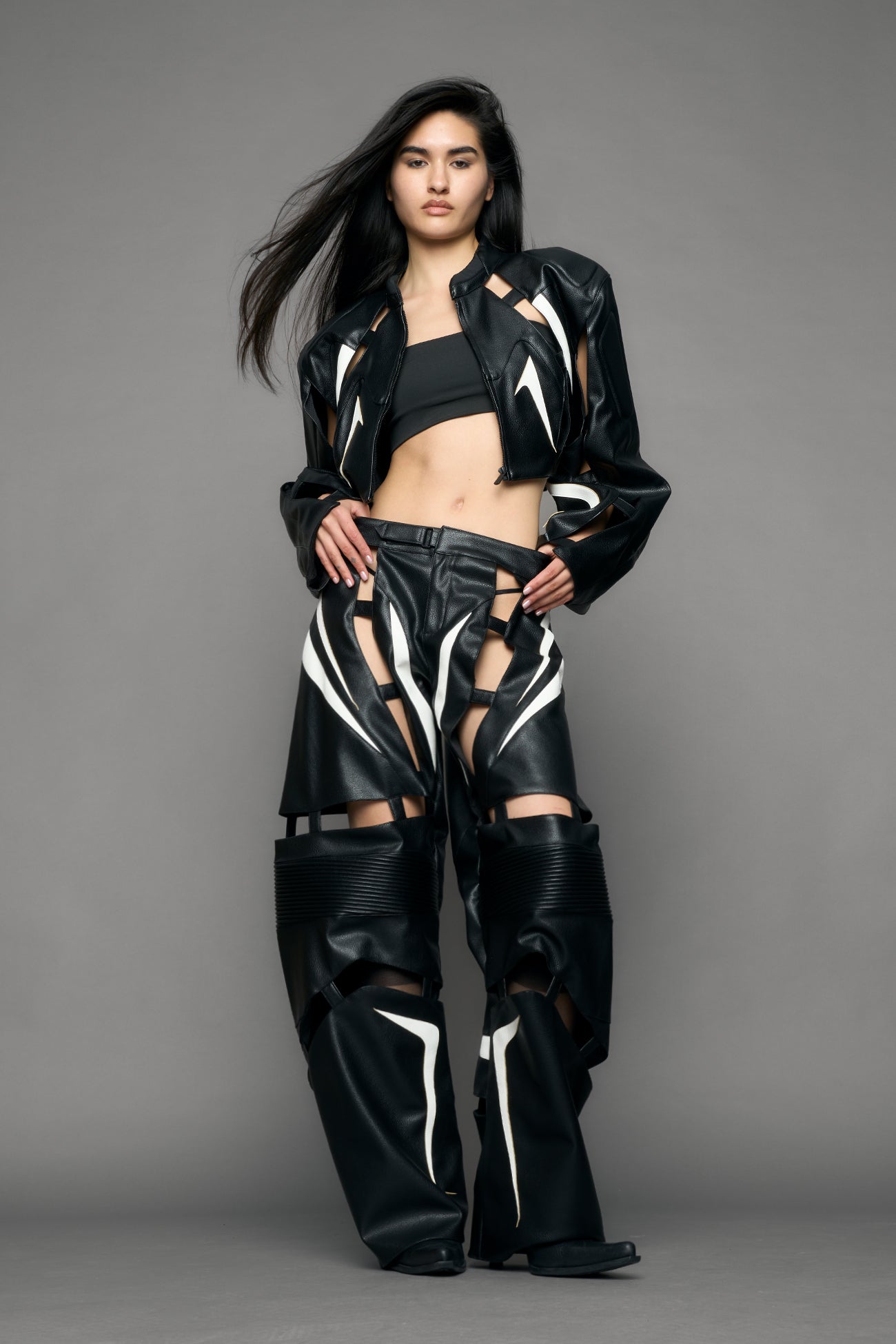 model wearing black and white moto pu leather jacket with cut out design