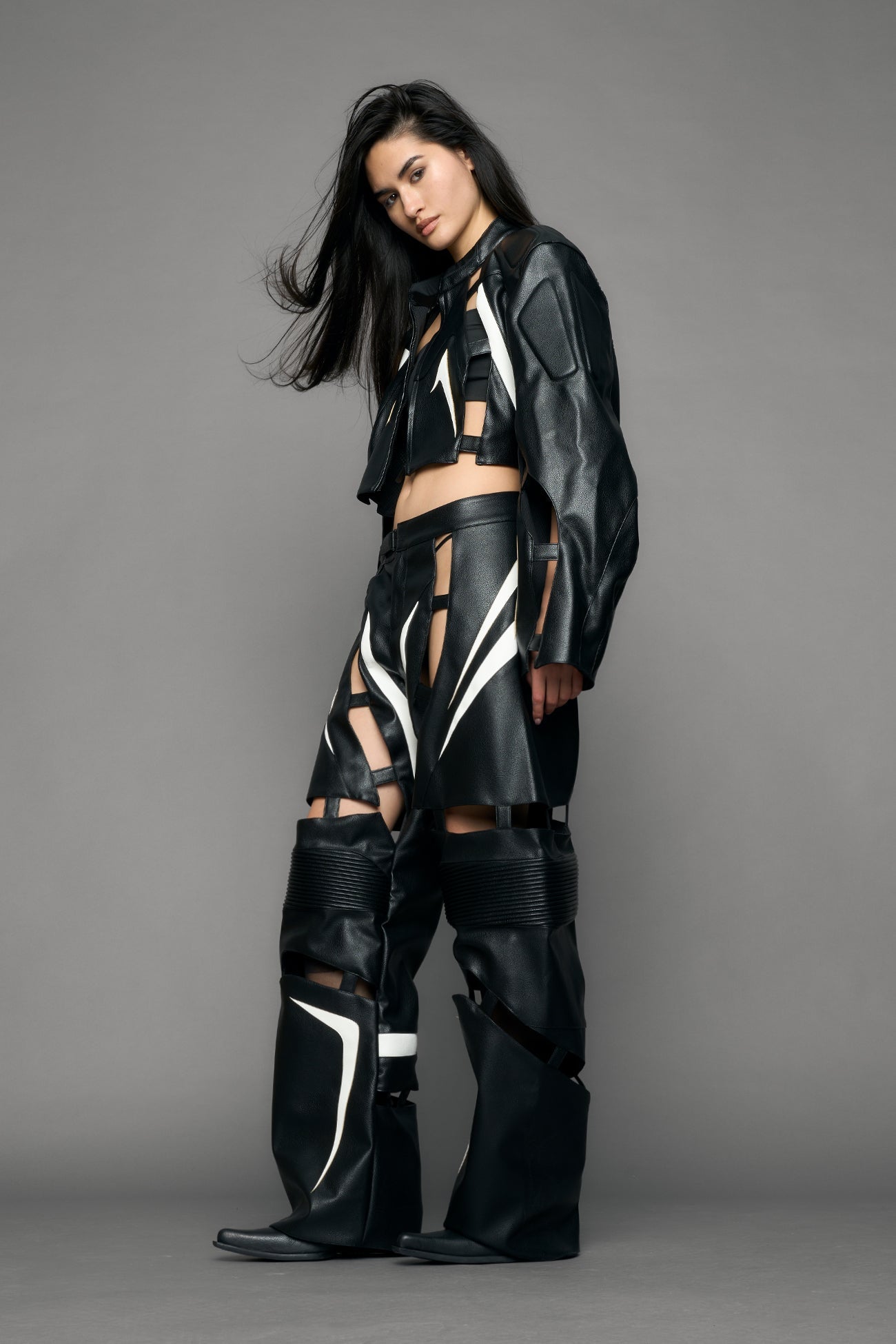 model wearing black and white moto pu leather jacket with cut out design