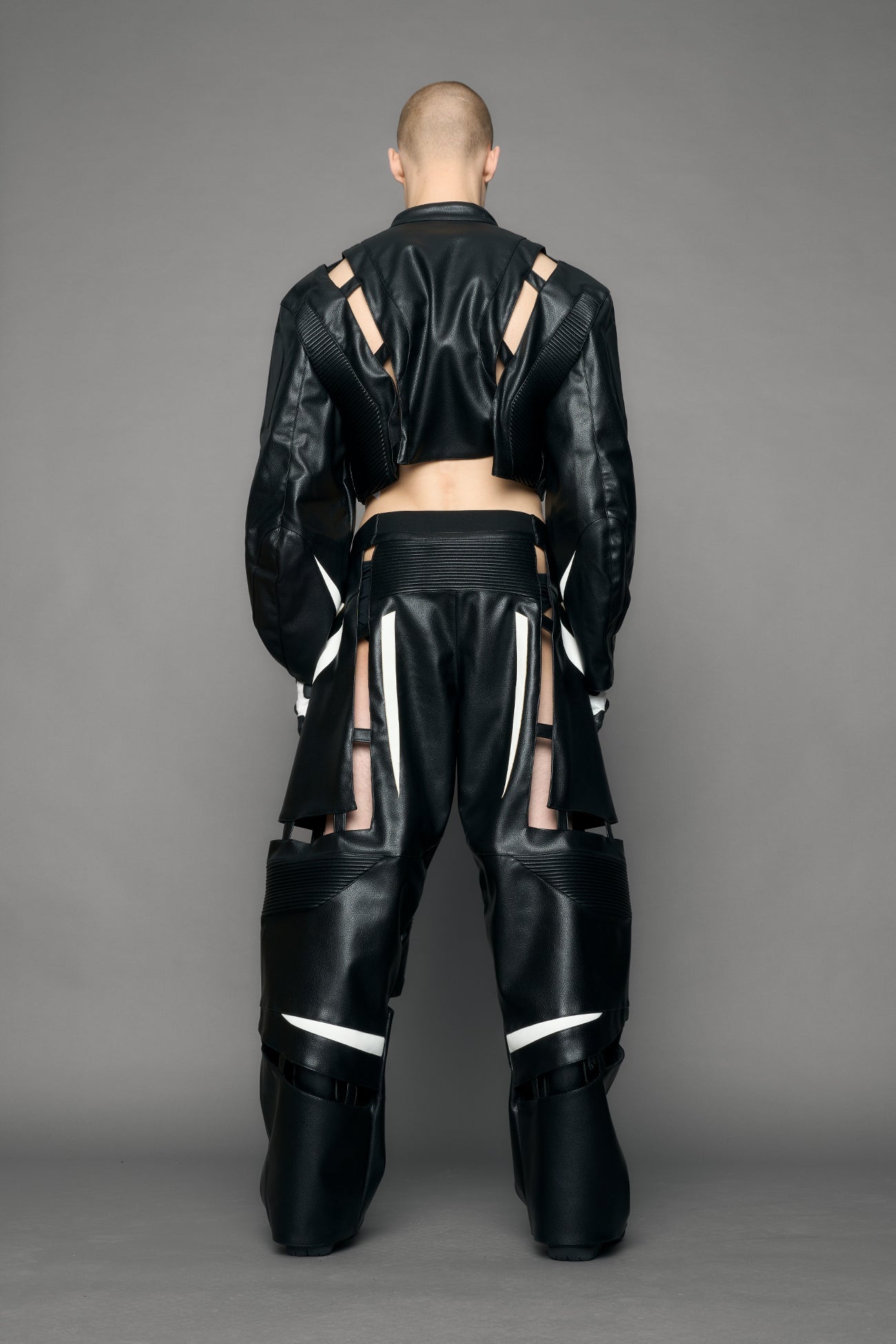 model wearing black moto pu leather jacket with cut out design