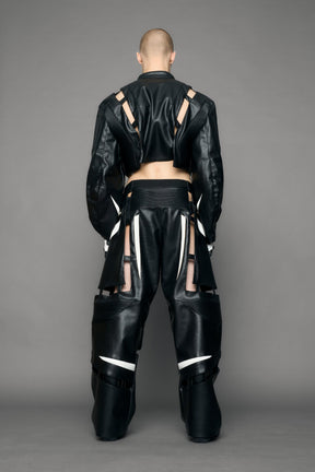model wearing black and white pu leather pants with cut out details