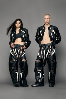 model wearing black and white pu leather pants with cut out details