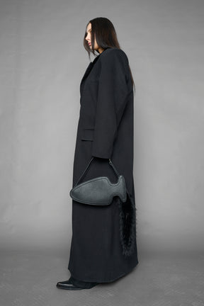 black butt plug bag with adjustable strap and faux fur detail worn as shoulder bag studio ecommerce image