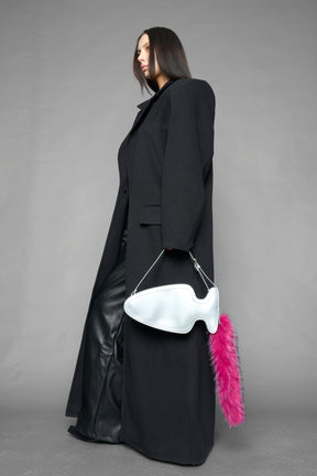 silver butt plug bag with adjustable strap and faux fur detail worn as shoulder bag studio ecommerce image