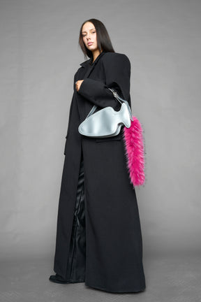 silver butt plug bag with adjustable strap and faux fur detail worn as shoulder bag studio ecommerce image