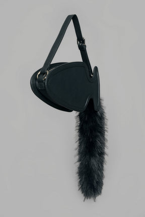 black butt plug bag with adjustable strap and faux fur detail worn as shoulder bag studio ecommerce image