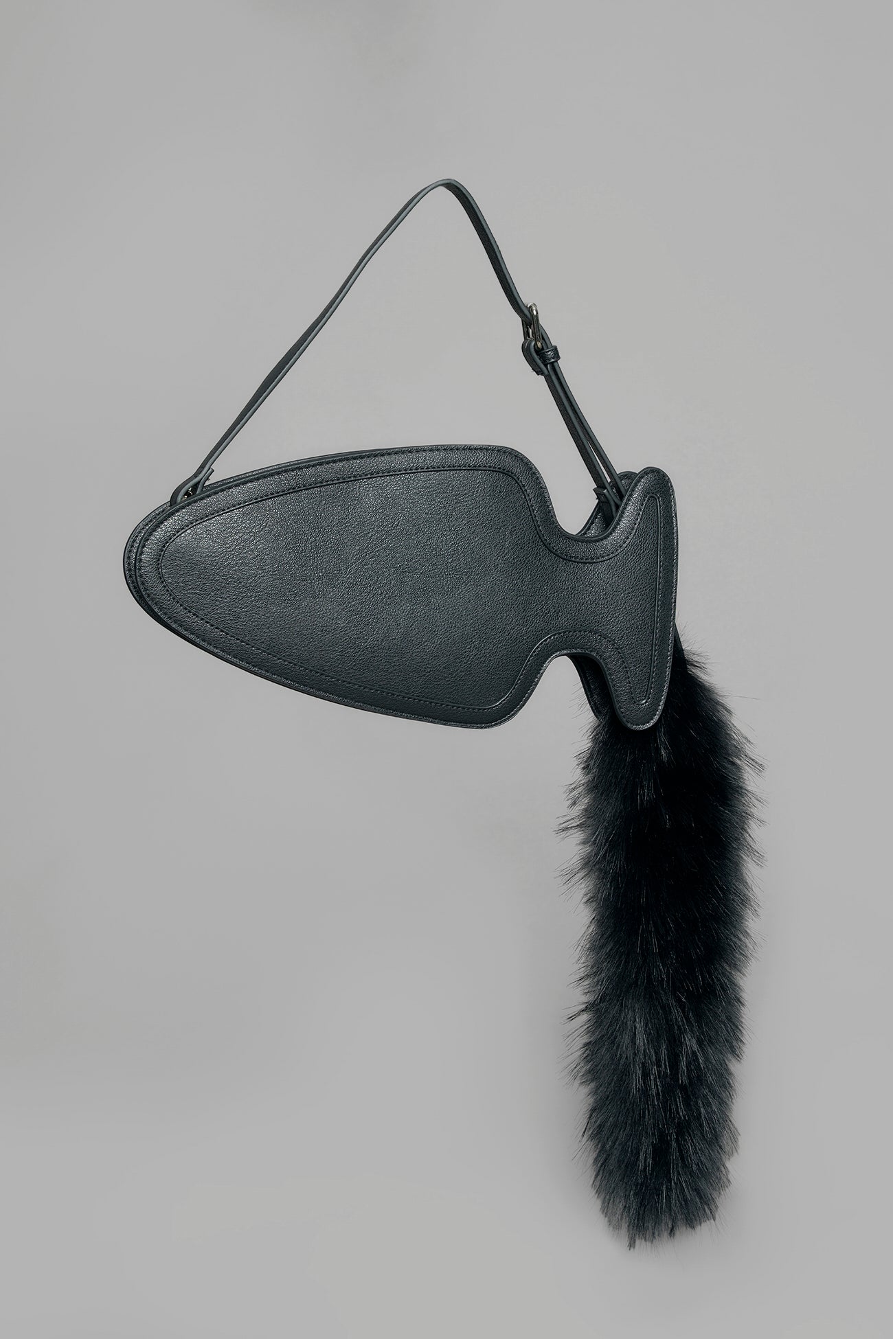 black butt plug bag with adjustable strap and faux fur detail worn as shoulder bag studio ecommerce image