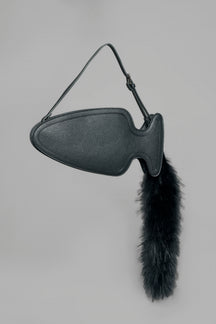 black butt plug bag with adjustable strap and faux fur detail worn as shoulder bag studio ecommerce image