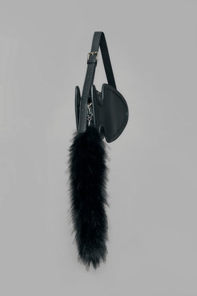 black butt plug bag with adjustable strap and faux fur detail worn as shoulder bag studio ecommerce image