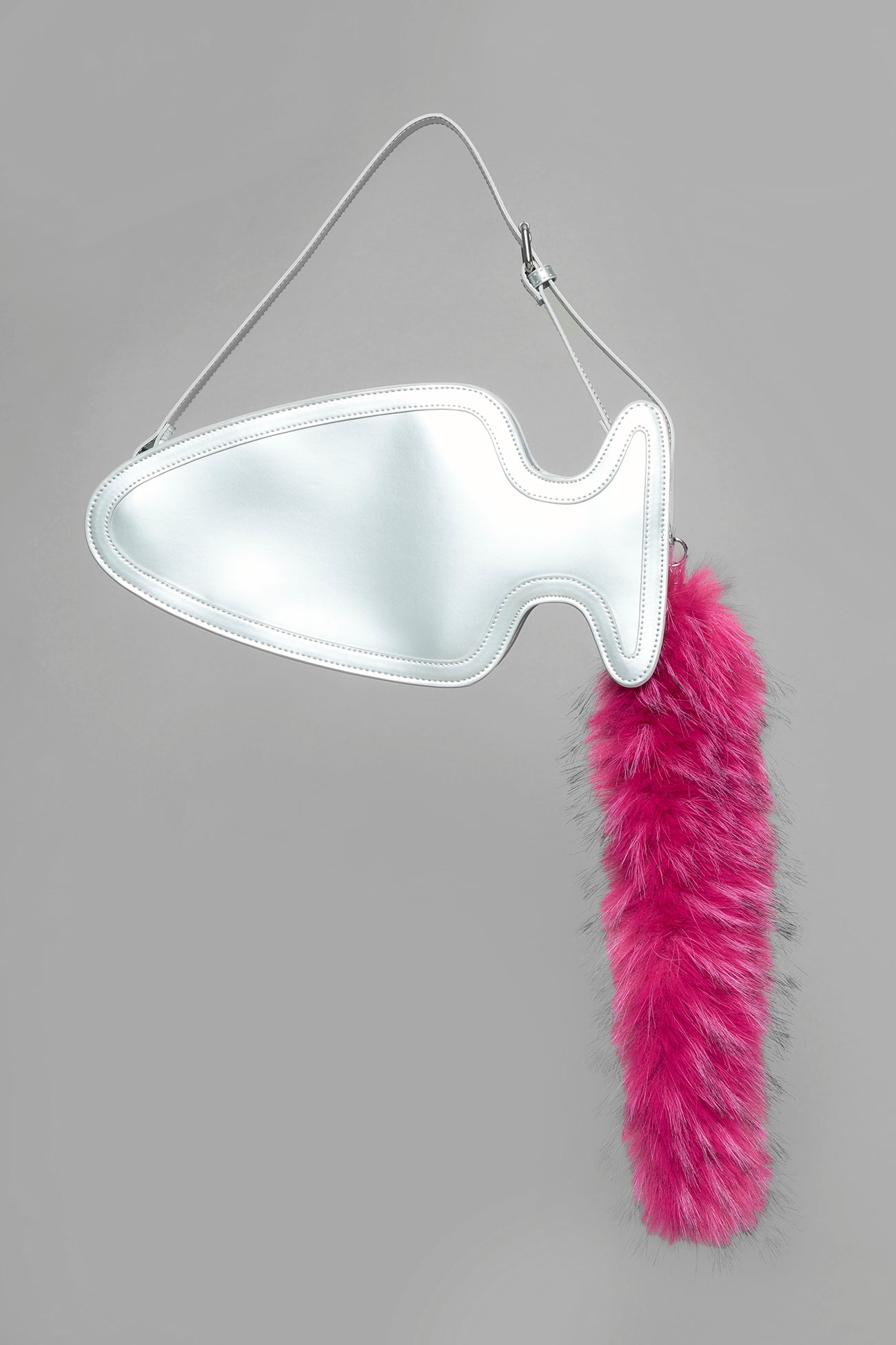 silver butt plug bag with adjustable strap and faux fur detail worn as shoulder bag studio ecommerce image