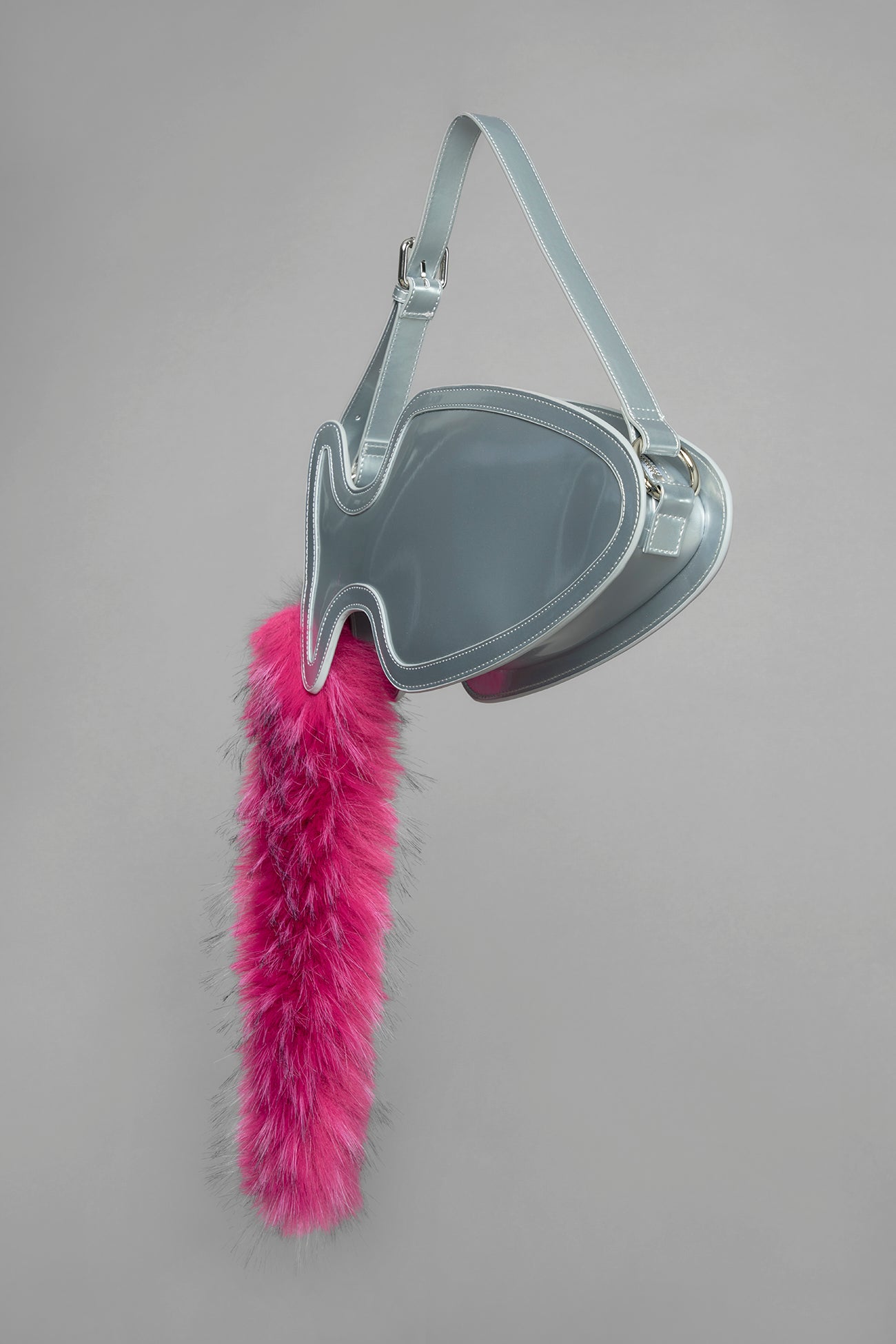 silver butt plug bag with adjustable strap and faux fur detail worn as shoulder bag studio ecommerce image