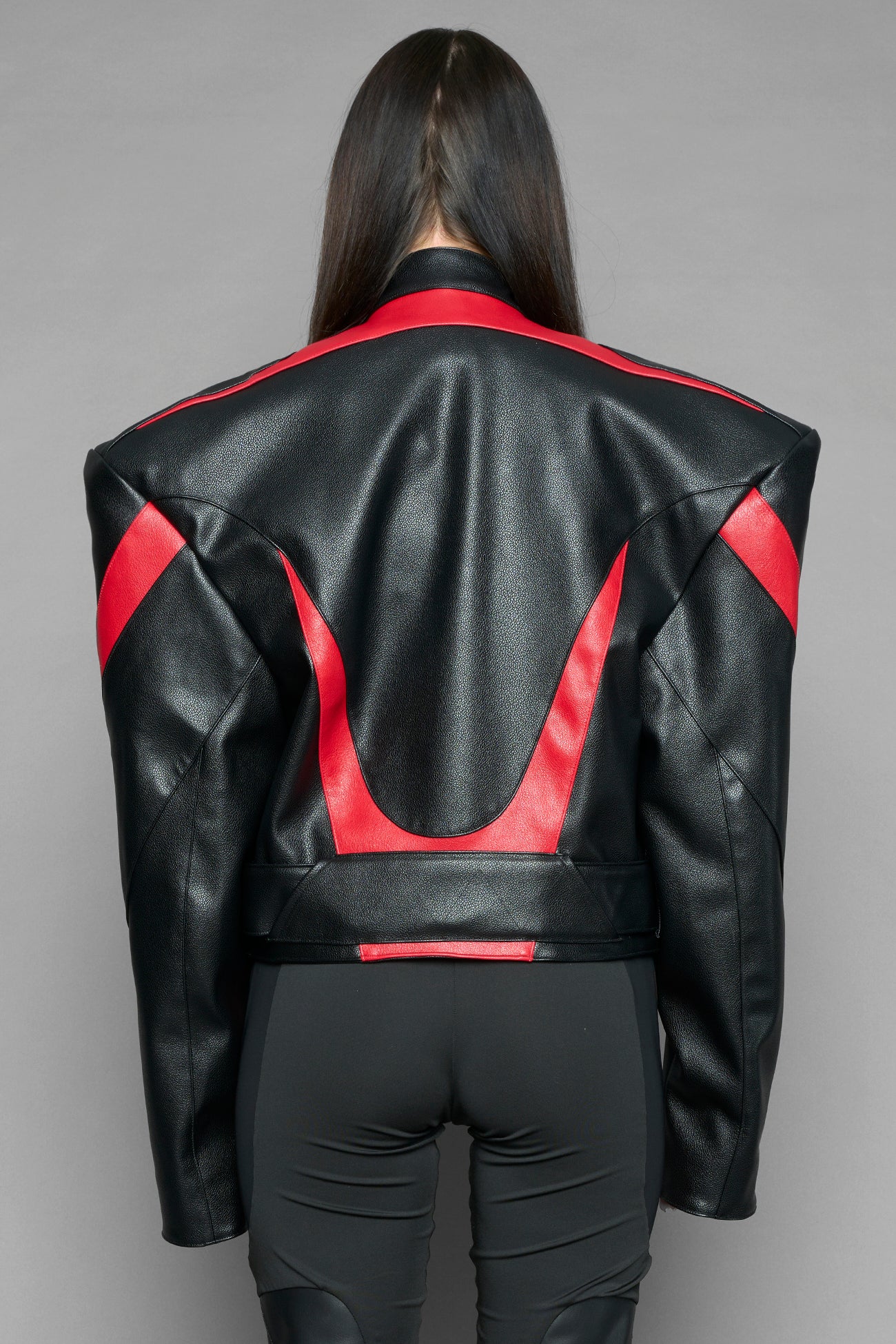 black red power shoulder moto jacket with extreme sculpted shoulders and integrated boning construction worn by models studio ecommerce image