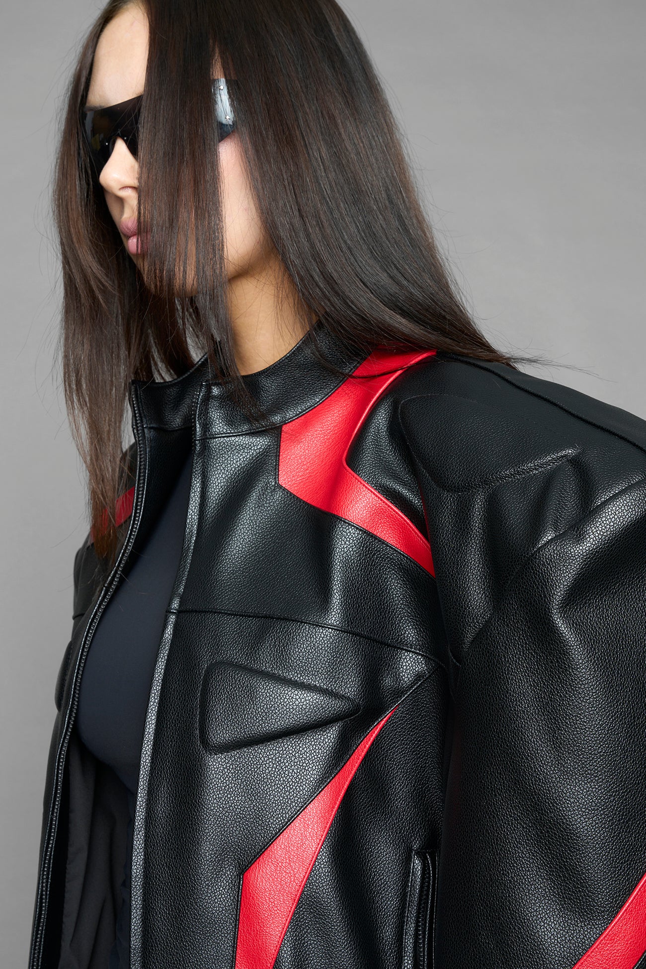 black red power shoulder moto jacket with extreme sculpted shoulders and integrated boning construction worn by models studio ecommerce image