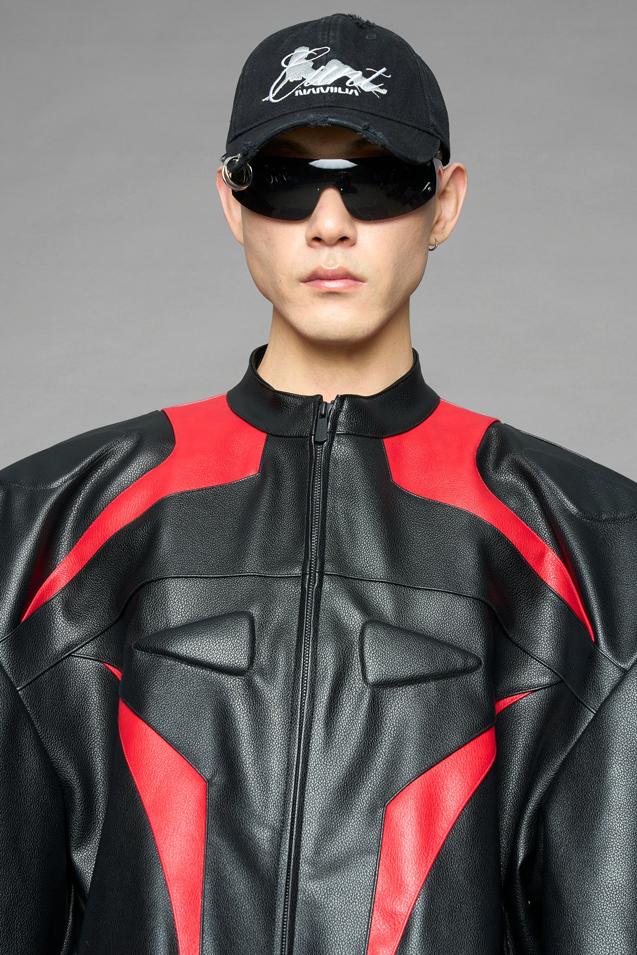 black red power shoulder moto jacket with extreme sculpted shoulders and integrated boning construction worn by models studio ecommerce image