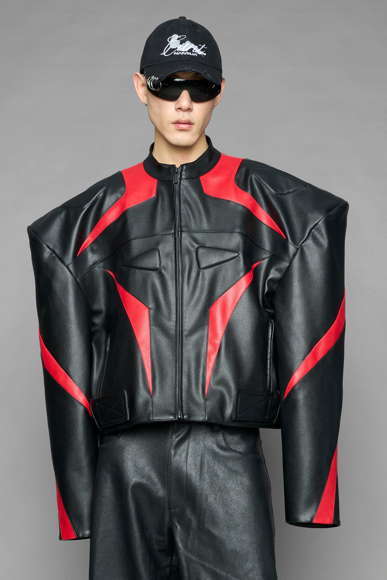 black red power shoulder moto jacket with extreme sculpted shoulders and integrated boning construction worn by models studio ecommerce image