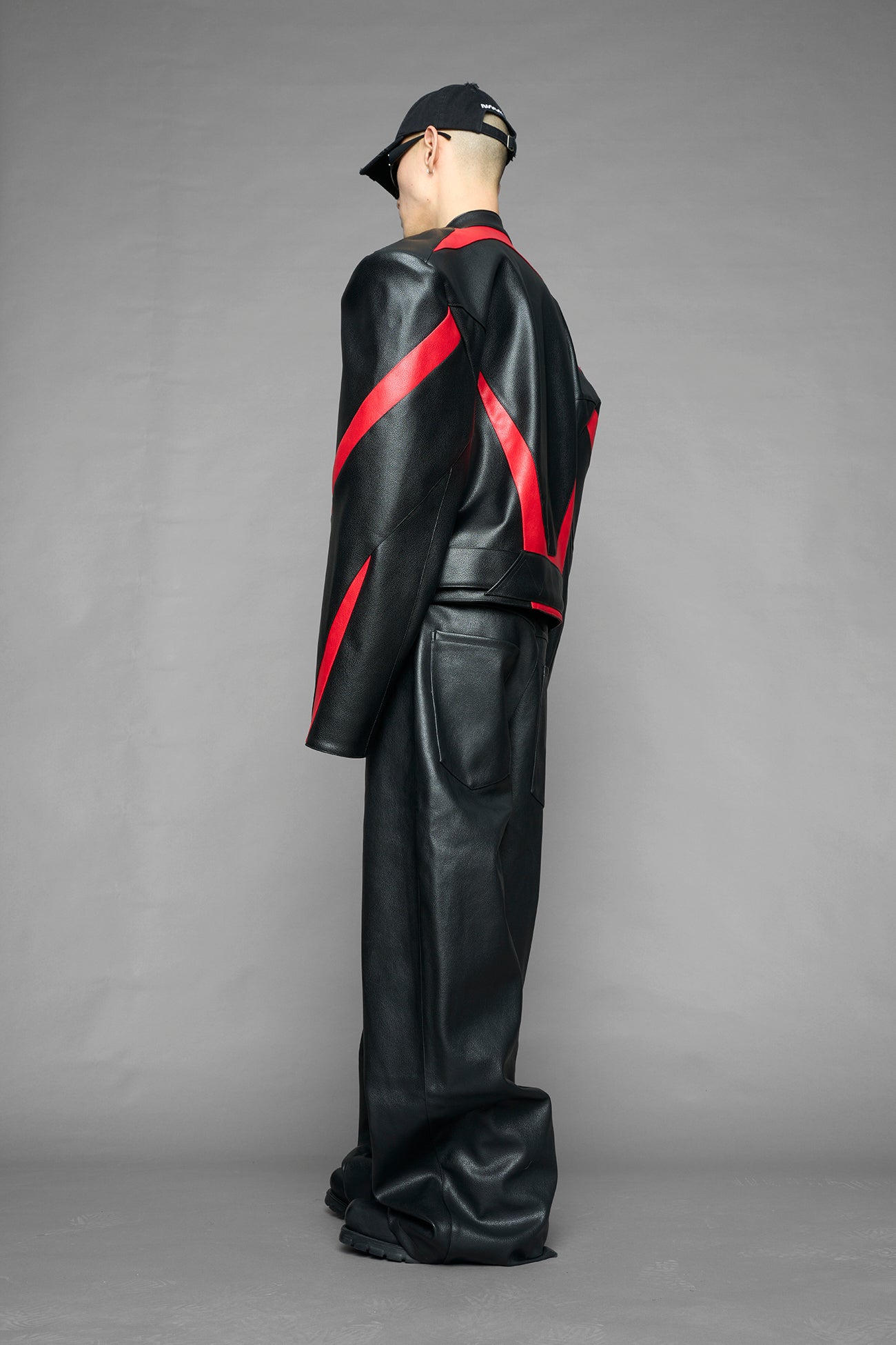 black red power shoulder moto jacket with extreme sculpted shoulders and integrated boning construction worn by models studio ecommerce image