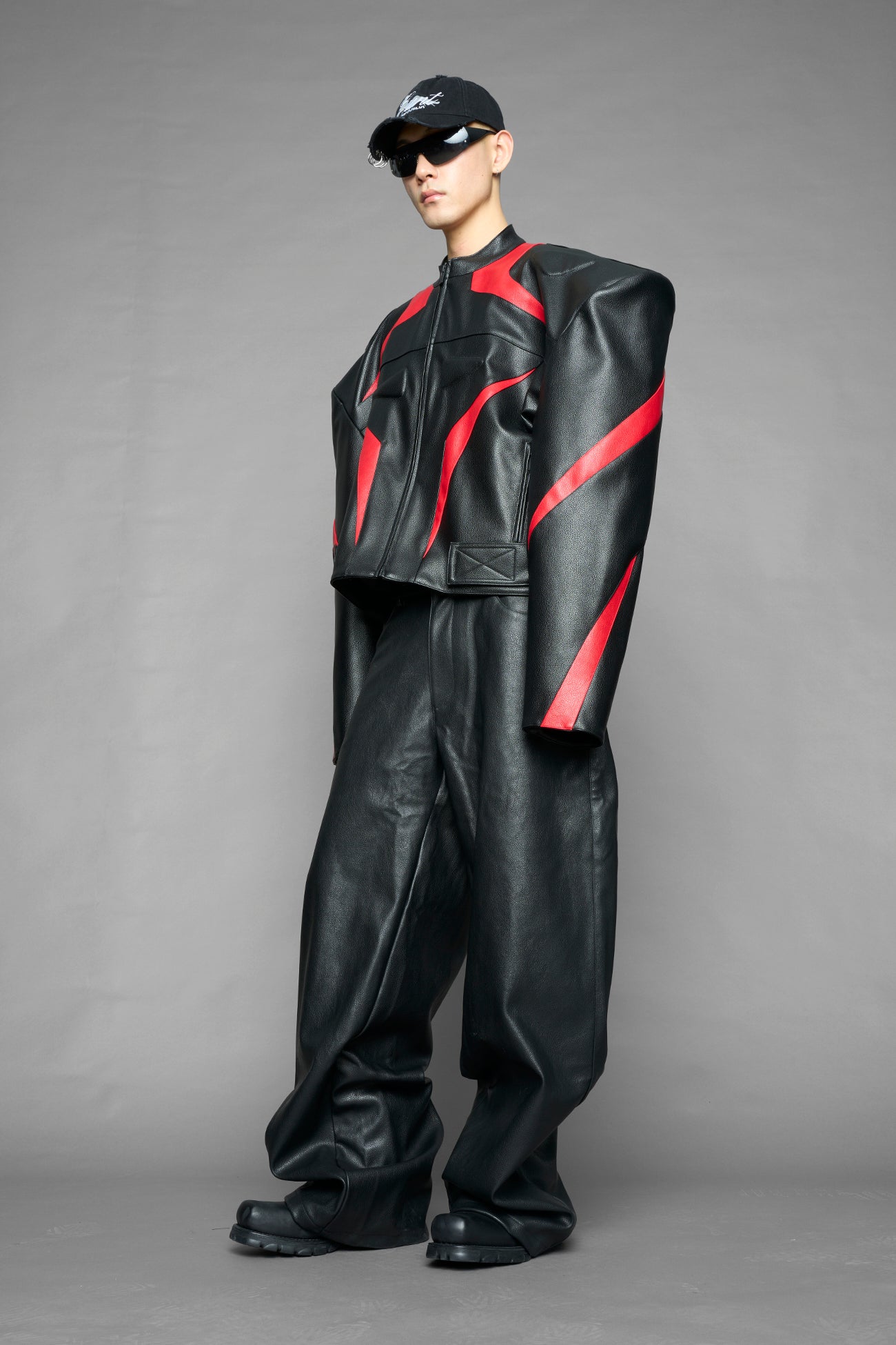 black red power shoulder moto jacket with extreme sculpted shoulders and integrated boning construction worn by models studio ecommerce image
