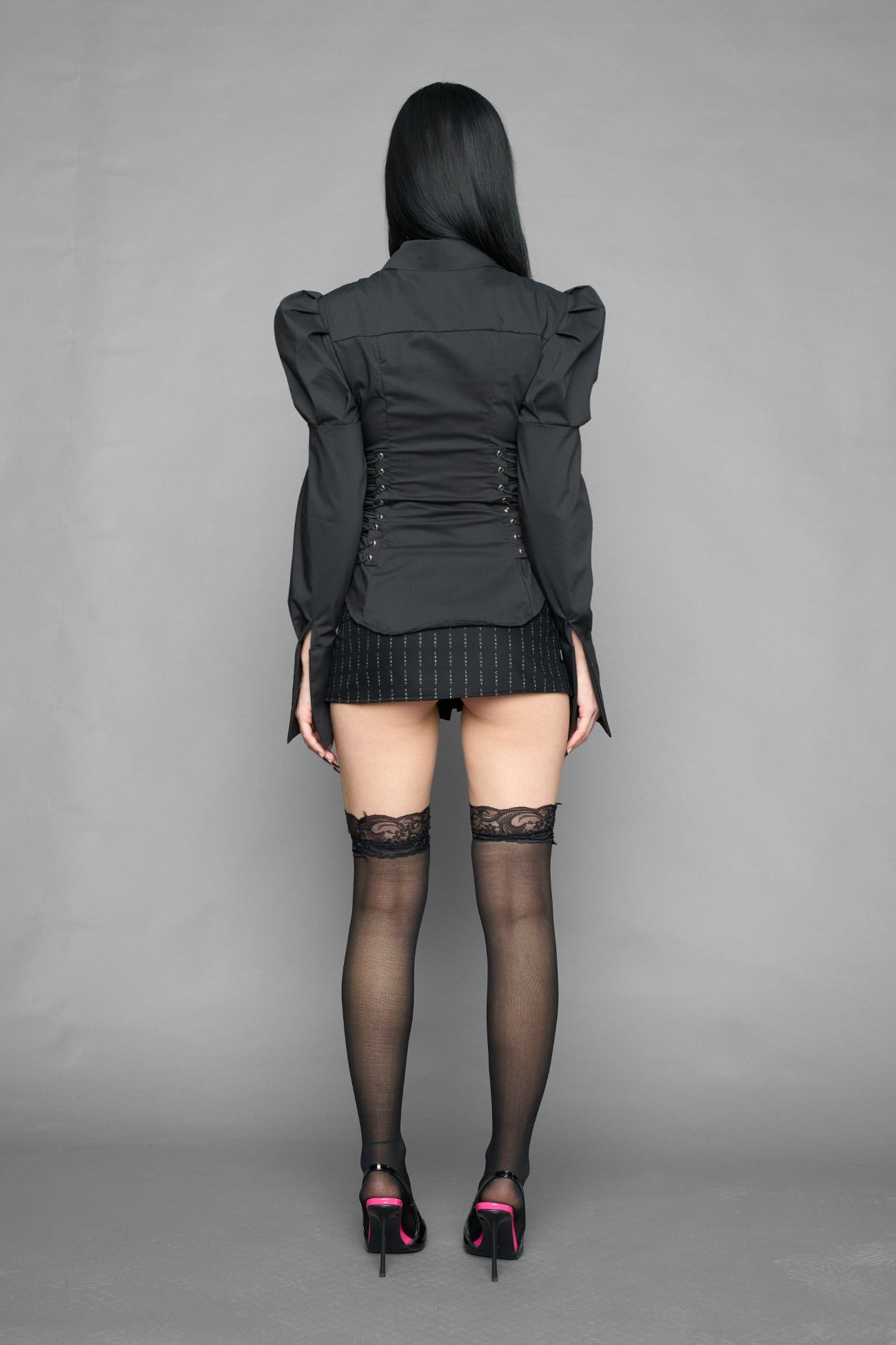 black puff shoulder blouse with corset lace up sides and button front worn by model studio ecommerce image