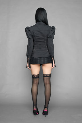 black puff shoulder blouse with corset lace up sides and button front worn by model studio ecommerce image