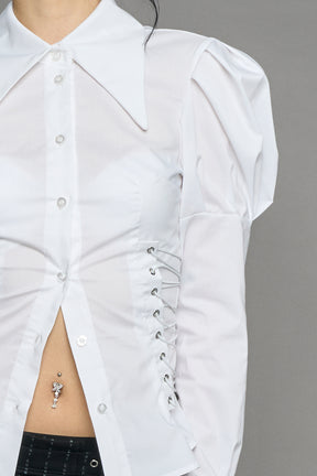 white puff shoulder blouse with corset lace up sides and button front worn by model studio ecommerce image