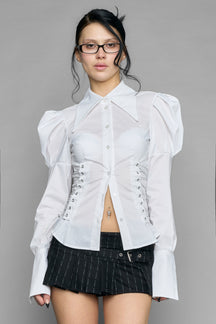 white puff shoulder blouse with corset lace up sides and button front worn by model studio ecommerce image
